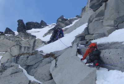 Mountaineers climbing through mixed terrain in the Cathedral Peaks outside of Haines