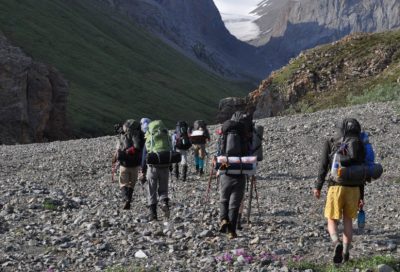 Hikers moving across the Donjek Route in Canada, practicing expedition travel and backcountry leadership skills.
