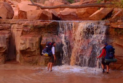 Outdoor leadership course participants admiring a waterfall section in a Utah canyon.