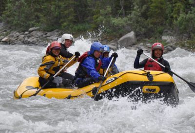 Whitewater rafting team navigating a rapid on the Blanchard River during guide training.