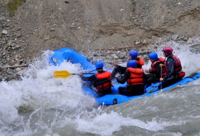 Adventure participants running a Class III–IV rapid on the Blanchard River in Alaska.