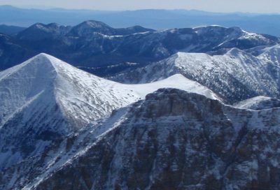 High-elevation Utah mountain range with fresh snow and rugged alpine terrain.