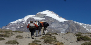 Mountaineers trekking toward Aconcagua under clear skies.