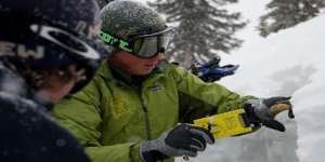 Instructor demonstrating snow analysis during an avalanche training course.