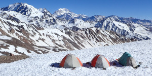 Expedition campsite on a snowy ridge in the Andes.