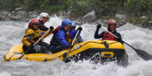 Rafting team navigating strong whitewater