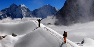 Climbers traversing a high alpine ridge in Nepal's Himalayan mountains